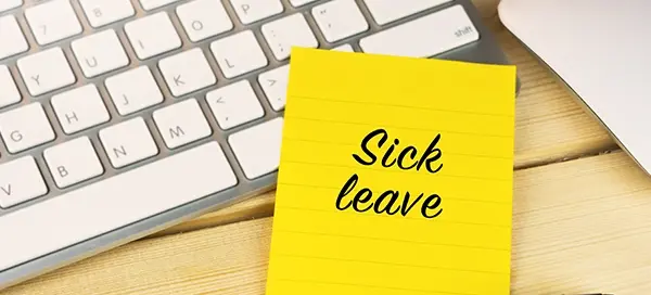 HR manager reviewing sick leave records and return-to-work forms