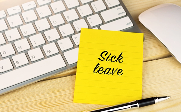 HR manager reviewing sick leave records and return-to-work forms