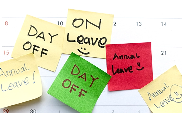 HR manager reviewing employee leave records on spreadsheet