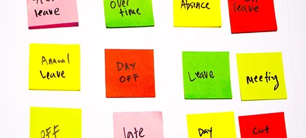 HR administrator managing employee sick leave records on spreadsheets