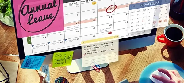 HR manager using annual leave management software to schedule employee leave across departments