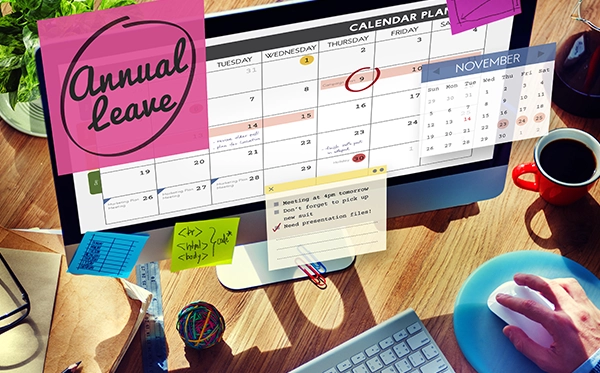 HR manager using annual leave management software to schedule employee leave across departments